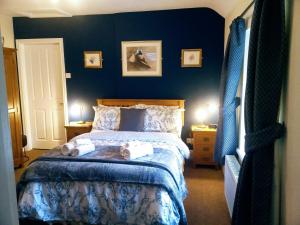 a bedroom with a bed with towels on it at Oakfield House Bed and Breakfast in Betws-y-coed