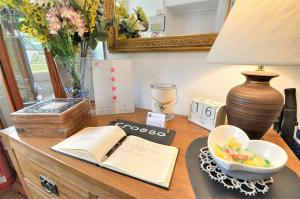 a desk with a lamp a book and a bowl of fruit at Oakfield House Bed and Breakfast in Betws-y-coed +18 photos