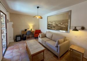 a living room with a couch and a table at Hôtel Casa Rossa & Spa in LʼÎle-Rousse