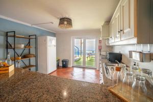a kitchen with a counter top and a refrigerator at Saltline Surf House Ericeira in Ericeira