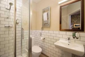 a bathroom with a toilet and a sink and a shower at The Wordsworth, Grasmere - The Inn Collection Group in Grasmere +23 photos