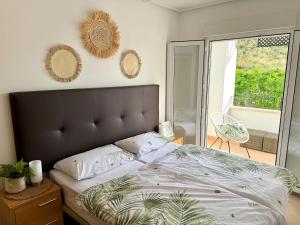 a bedroom with a large bed and a balcony at Casa Sofinata with Pool View & Golf in Sucina +34 photos