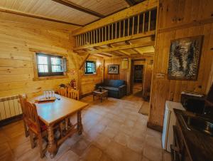 a living room with a table and a couch in a cabin at La Posada Cercedilla in Cercedilla