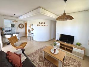 a living room with a couch and a tv at Casa Sofinata with Pool View & Golf in Sucina