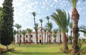 a building with palm trees in front of it at Casa Sofinata with Pool View & Golf in Sucina