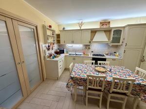 a kitchen with a table and chairs and a kitchen with a stove at Casa Etna Soul in Paterno