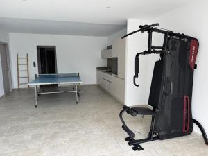 a gym with a ping pong table in a room at Résidence du Château d'eau in Porticcio
