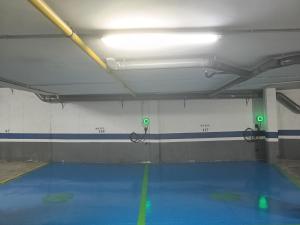a gym room with a blue floor and green lights at Hotel Palacio Congresos in Palencia