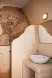 a bathroom with a sink and a mirror at Ios Pearls-2 houses in Mylopotas +80 photos