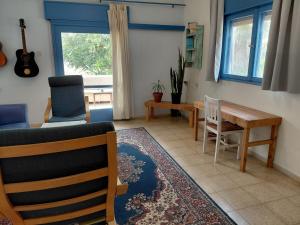a living room with a couch and a table and chairs at Amit house in Pardes H̱anna