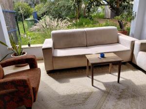 a living room with a couch and a coffee table at Amit house in Pardes H̱anna