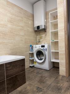 a laundry room with a washing machine and a sink at Prestige Suite DS in Dunajská Streda