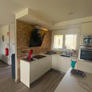 a kitchen with white cabinets and a microwave at My Reyna in San Miguel +37 photos