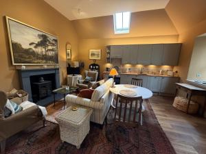 a living room with a couch and a table at Barns Studio in Peebles