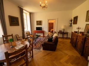 a living room with a couch and a table at Château de Courcelles in Équevilley