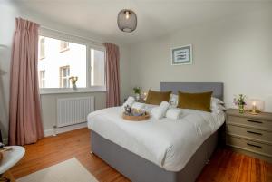 a bedroom with a large bed and a window at The View in Sidmouth