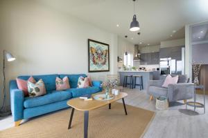 a living room with a blue couch and a table at The View in Sidmouth +18 photos