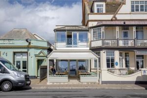a woman standing in front of a house at The View in Sidmouth