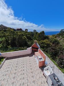 an outdoor patio with a view of the ocean at Eiras AL Ilha da Madeira in Santa Cruz