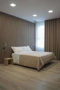 a bedroom with a large bed and a window at Hotel La Casa Del Pellegrino in SantʼAnastasia +42 photos