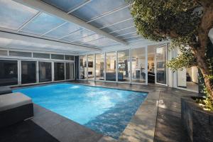 a large swimming pool in a house at Bed & Wellness Angie in Almere
