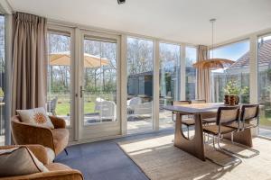 a living room with a table and chairs at Groenendijk Verhuur Vakantiewoning Casa Iris in Burgh Haamstede