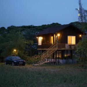 a house with a car parked in front of it at APKA ECOvillage in Trichūr