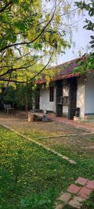 a building with a bench in front of it at APKA ECOvillage in Trichūr