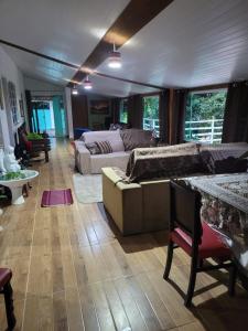 a living room with a couch and a table at Pousada Recanto Dos Pássaros in Colégio +59 photos