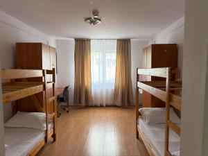 a room with three bunk beds and a window at ZipStay Inn in Cluj-Napoca