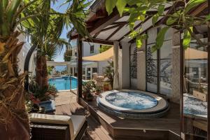 a hot tub on a deck next to a pool at Boutique Hotel Marco Polo in Gradac +91 photos