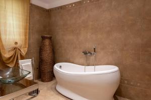 a bathroom with a tub and a toilet in a room at La Mia Reggia B&B in San Nicola La Strada +24 photos
