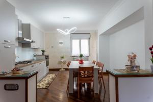 a kitchen with a table and a dining room at La Mia Reggia B&B in San Nicola La Strada