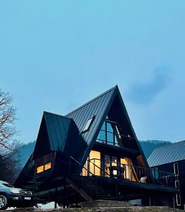 a large house with a gambrel roof and stairs at Mtis Racha in Oni