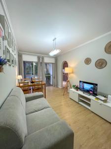 a living room with a couch and a tv at 2BR Estoril Apartment - Near Estoril Beach & Cascais - Sleeps 4 in Estoril
