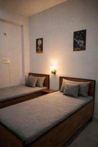 two beds sitting next to each other in a room at La vie Livings Only For Female in Noida