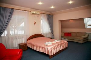 a hotel room with a bed and a couch at Sava Dream in Zhytomyr