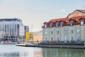a large building next to a body of water at Home Hotel Packhuset in Kalmar