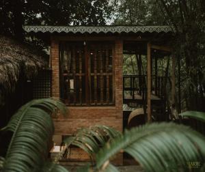 a small brick building with a window at Zen Marie Tanay in Sampong