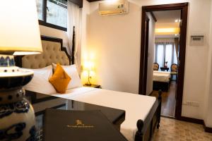 a hotel room with a bed and a mirror at Maison Julie Duong in Hanoi +41 photos