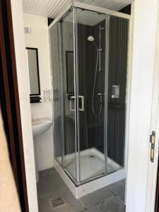 a glass shower in a bathroom with a toilet at Belvedere Costinesti in Costinesti