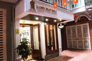 a building with a sign on the front of it at Maison Julie Duong in Hanoi