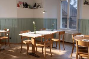 a dining room with tables and chairs and a window at Hotel Schloss Rued - Boutique Hideaway in Schlossrued +53 photos