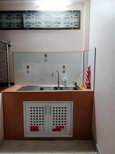 a small kitchen with a sink and a window at Padang Besar In front of Border Private room & Hostel in Sathani Padang Besa +34 photos
