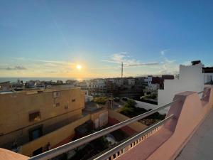 a view of the sunset from the balcony of a building at Mavi Surf Stay Tamraght in Tamraght Ouzdar