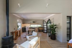 ein Wohnzimmer mit weißen Möbeln und einem Kamin in der Unterkunft Hemelberg in Stellenbosch