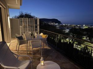 a patio with a table and chairs on a balcony at Villa Admare - LUX - minipiscina Spa vista mare - Spiaggia inclusa in Numana