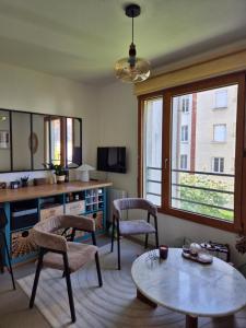 a living room with a table and chairs at Villa Sévigné in Nantes