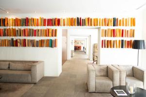 a living room with books on the wall at Hotel Carris Porto Ribeira in Porto +45 photos