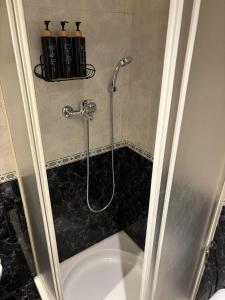 a bathroom with a shower with a tub at Setúbal Sunset Apartment in Setúbal +28 photos